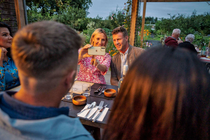 Couples taking videos of their Slemish Market Supper Club experience